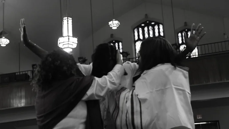 Worshippers with raised hands in Paseo Baptist Church